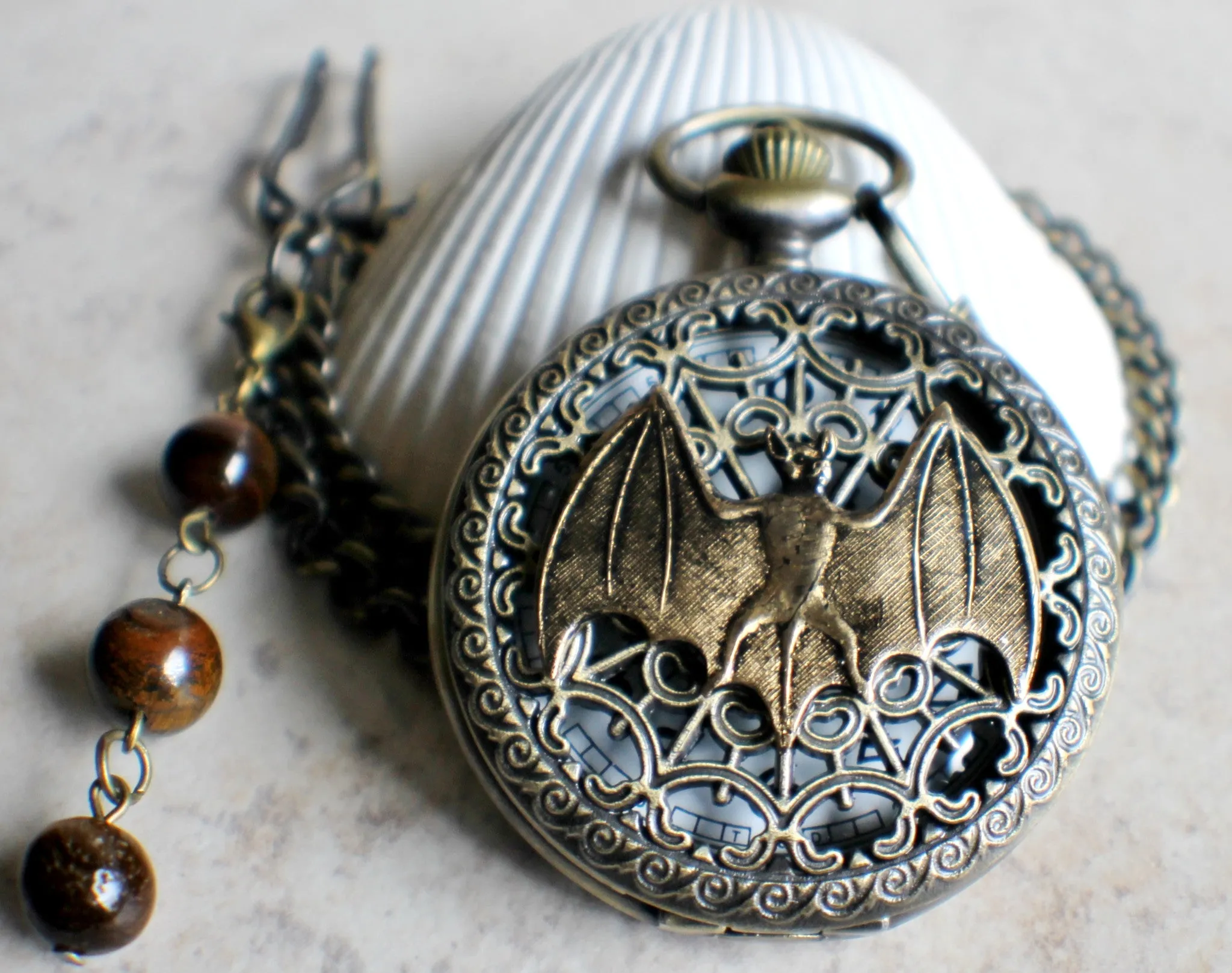 Bat battery operated pocket watch in bronze.