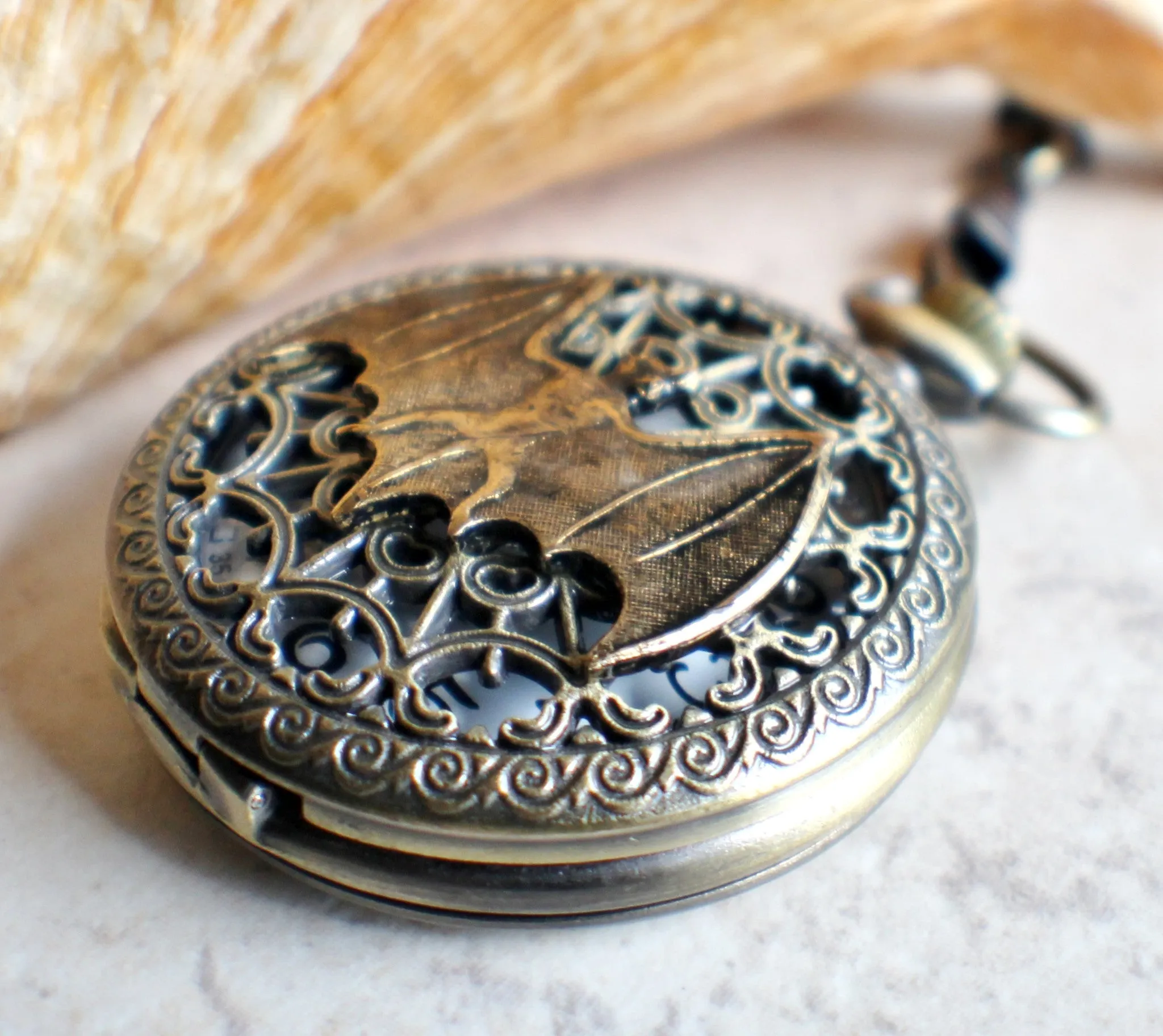 Bat battery operated pocket watch in bronze.
