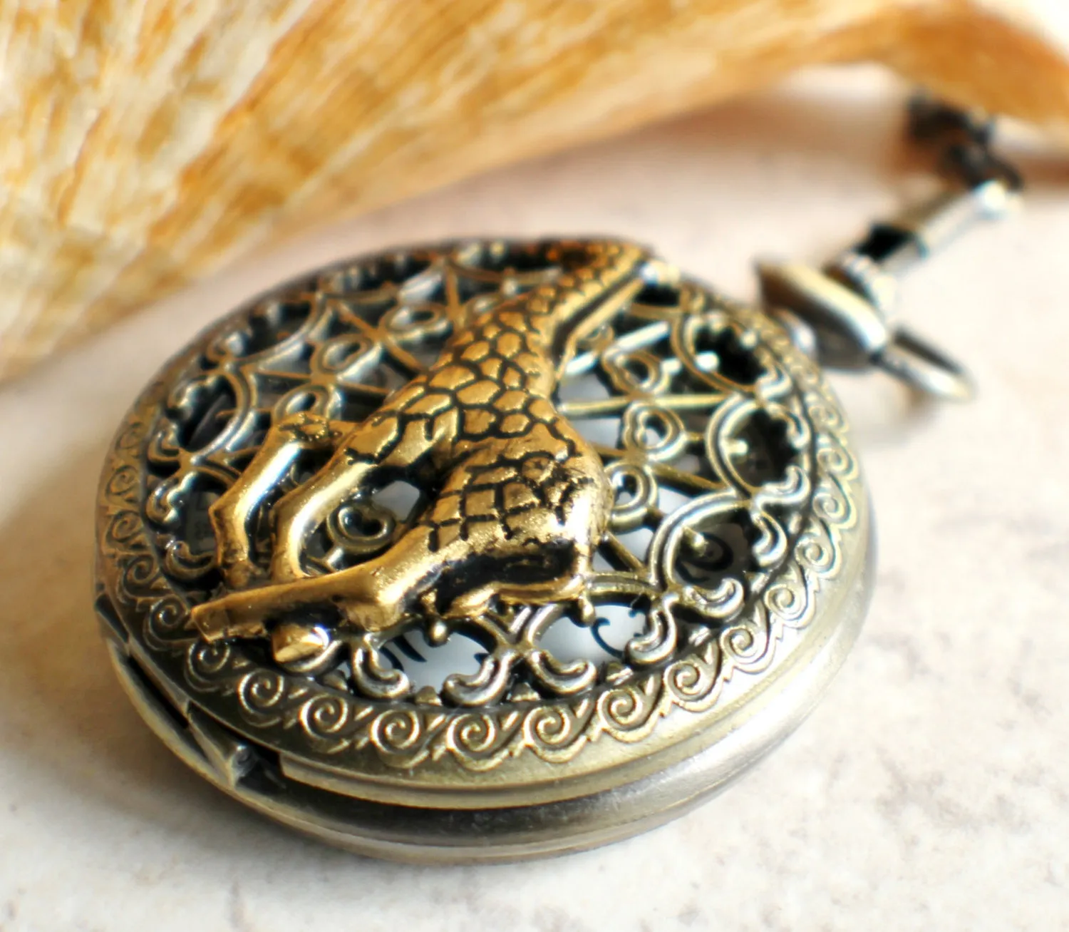 Giraffe battery operated pocket watch in bronze.