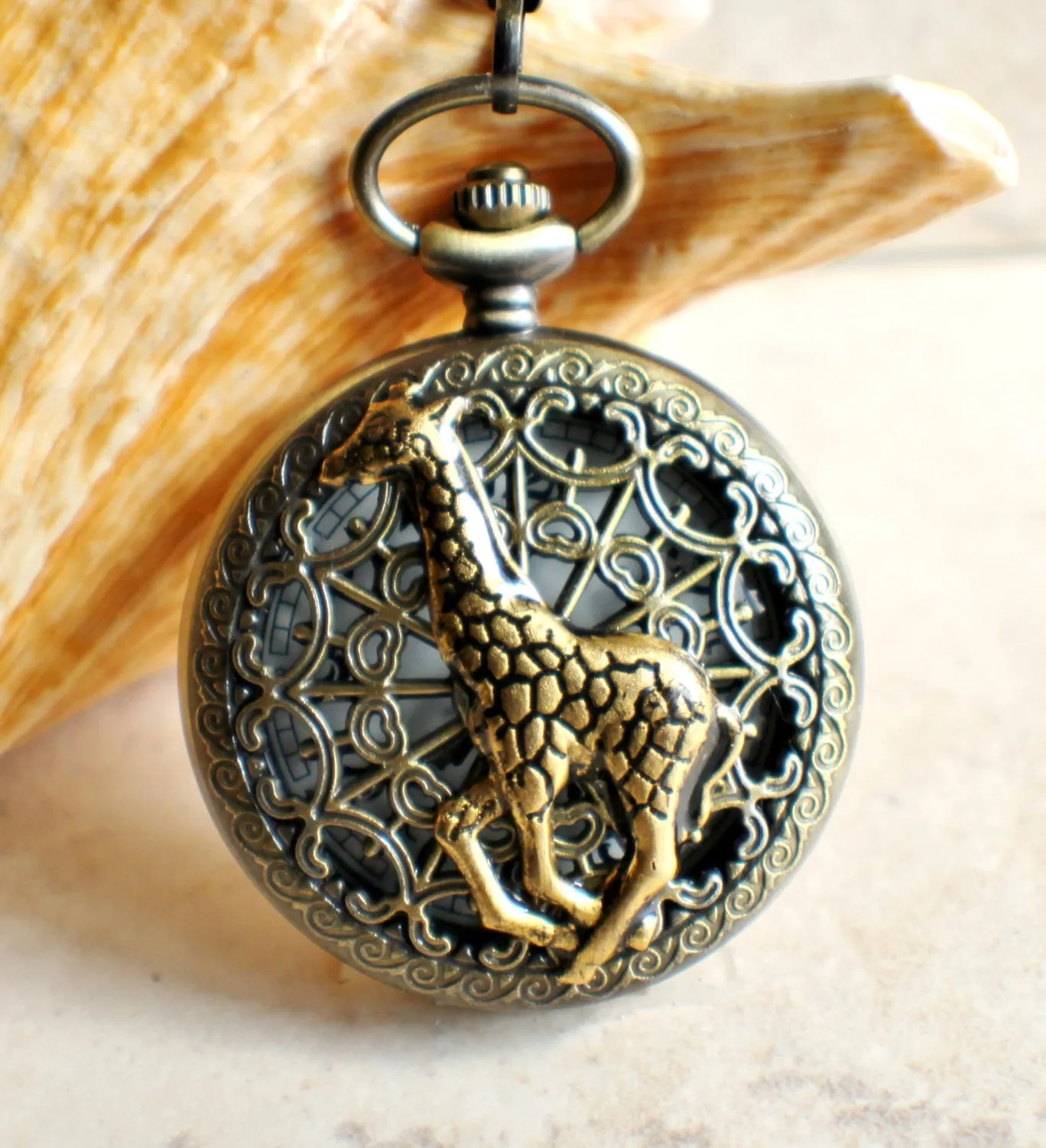 Giraffe battery operated pocket watch in bronze.