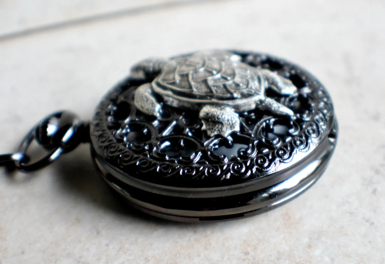 Turtle pocket watch battery operated in black.